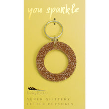 Load image into Gallery viewer, Gold glittery letter &quot;O&quot; keychain on a yellow card with &quot;you sparkle&quot; in gold text, displayed against a white background.