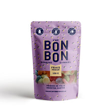 Load image into Gallery viewer, Purple C'est Bon Bon gummies pouch with yellow polka dots and colorful Easter inspired candies visible inside, displayed  on a white background.