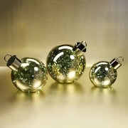 Load image into Gallery viewer, Three oversized gold metallic glass ornaments in varying sizes with flat bottoms, metal rings at the top, and  LED lights. Displayed on a gold surface with a gold background. 