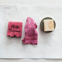 Load image into Gallery viewer, Two pink face towels with text embroidered on them, one with &quot;Hello Gorgeous&quot;  and the other with &quot;Hello Beautiful&quot;, displayed on a white surface with a bar of soap in a soap dish to the side.