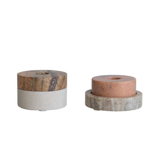 Two cylindrical  taper candle holders with natural wood and marble finishes on a white background.
