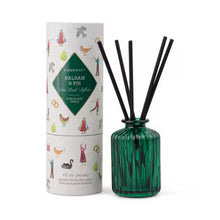 Load image into Gallery viewer, Green ribbed glass diffuser bottle with five black reed sticks inside, and a cylindrical packaging container on a white background. Packaging container is white with a green colored triangle label with the text &quot;BASLAM &amp;FIR&quot;, and various decorations including a hen, a goose, a milkmaid, golden rings, a dove, and people.