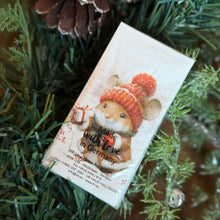 Load image into Gallery viewer, IHR pocket tissue pack featuring an illustration of a smiling brown mouse wearing a rat hat, scarf, and holding a small wrapped gift. Displayed among green garland and a pinecone.  