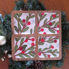 Load image into Gallery viewer, Four-section mango wood and white ceramic tray featuring a winter berry design with green leaves, red berries, and light blue snowflakes, displayed on a wooden surface with garland, pinecones, and silver ball ornaments. 