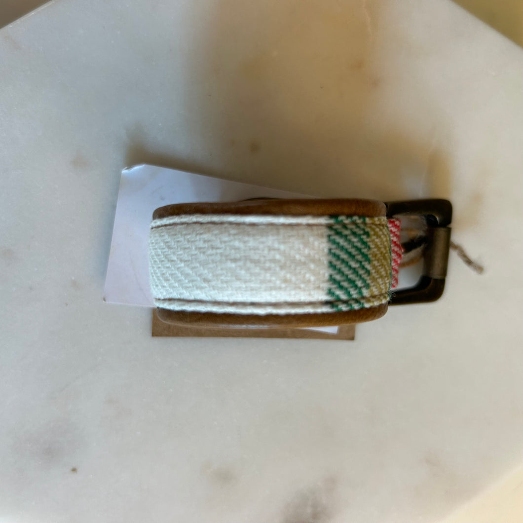 White and green flannel pet leash with a leather trim on a marble white background. 
