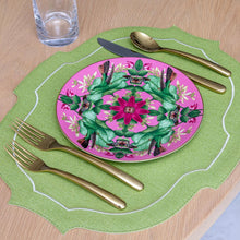 Load image into Gallery viewer, Decorative plate with floral design on a green placemat with cutlery and a glass on a brown table top.