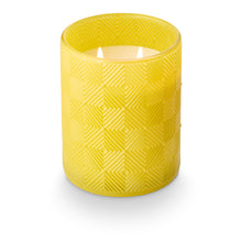 Load image into Gallery viewer, Lemongrass &amp; Lime Leaves Glass Candle, lit double-wick candle in yellow glass vessel with raised diamond geometric pattern shown in angled top view against white background. 