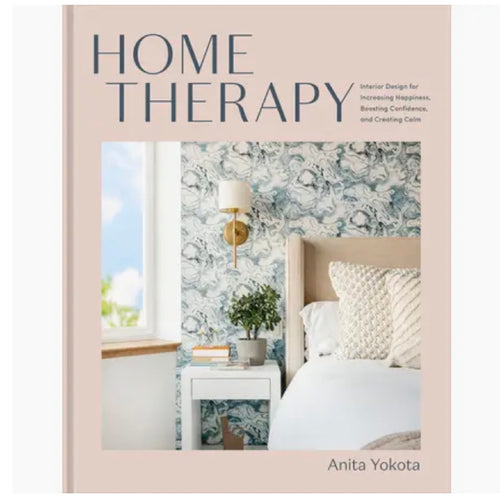 Cream hardcover book with a photo of a blue and white bedroom with window. Title in blue reads 