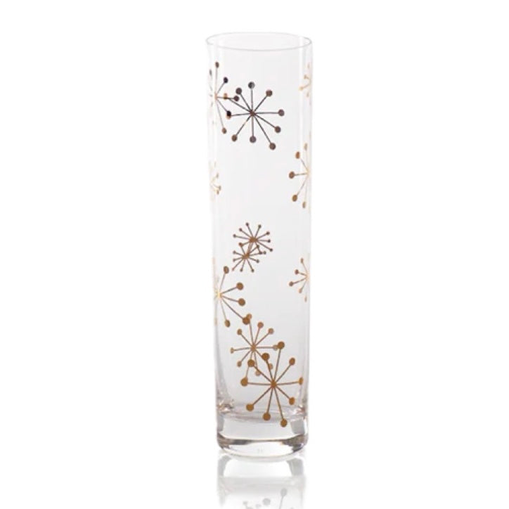 Clear glass champagne flute with gold starburst decals displayed on a white background.