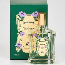 Load image into Gallery viewer, Granado Verbena cologne in clear glass bottle with gold cap and purple floral label  beside matching green Verbena box against a white background. 