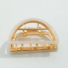 Load image into Gallery viewer, Ivory half-moon metal claw clip with gold hardware displayed on a white background.