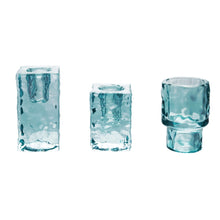 Load image into Gallery viewer, Hammered Glass Taper Holder, three aqua blue hammered glass candle holders in tall rectangular, short rectangular, and cylindrical pedestal shapes against white background. 