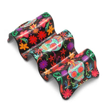 Load image into Gallery viewer, Multi Taco Holder, curved two-section melamine taco holder with aqua Day of the Dead sugar skulls and floral designs in purple, golden yellow, red, and pink on black background, displayed on white background.