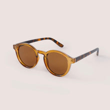Load image into Gallery viewer, Shoshana Dark Tortoiseshell Sunglasses, round polycarbonate frames with golden brown front and dark tortoiseshell arms, brown lenses, angled side view against a white background. 
