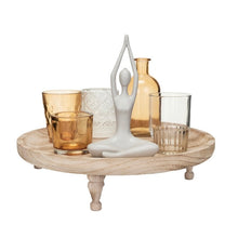 Load image into Gallery viewer, Footed Tray With Votive Holders, Vase, &amp; Yoga Figure Set, round wood footed tray with assorted glass holders, amber vase, and a seated white metal yoga figure against white background. 