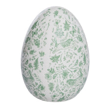 Load image into Gallery viewer, Rustic ceramic egg figurine with green floral, botanical, and rabbit pattern, displayed on a white background. 