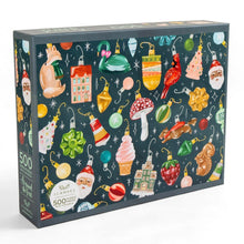 Load image into Gallery viewer, Boxed 500-piece jigsaw puzzle featuring colorful vintage-style Christmas ornaments illustrated on a dark background, displayed upright against a white surface.
