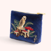 Load image into Gallery viewer, Royal blue velvet mini pouch embroidered with a brown, gold, and white owl perched on a brown tree stump among red and white mushrooms and green ferns. Finished with a gold zipper. A yellow embroidered cursive &quot;P&quot; on the lower right corner. Pouch is displayed against a white background.  