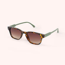 Load image into Gallery viewer, Jacinda Moss Tortoiseshell Sunglasses, classic rectangular frames with tortoiseshell fleck front and moss green arms, brown gradient lenses, angled side view against a white background. 