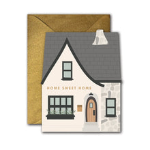 Load image into Gallery viewer, Home Sweet Home Die-Cut folded Card with house-shaped design, white house, gray roof, stone chimney and exterior detail, floral window box, and glittery gold envelope against white background.