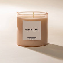 Load image into Gallery viewer, Poured NY Flesh &amp; Fuzz candle in clear glass vessel with peach-toned wax, displayed on a white surface. 