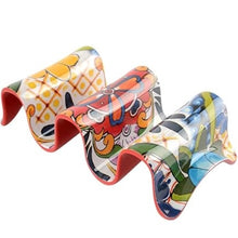 Load image into Gallery viewer, Multi Taco Holder, curved two-section melamine taco holder with colorful assorted geometric and floral designs and red underside, displayed on white background. 