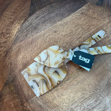 Load image into Gallery viewer, Tortoise Resin Cheese Utensil Set three stainless steel utensils with tortoise shell resin design in ivory, brown, and amber tones including spreader, fork, and knife, shown with black tag brand label on wooden surface. 