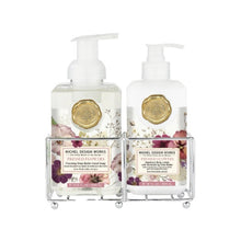 Load image into Gallery viewer, Michel Design Works Pressed Flowers shea butter foaming hand soap and body lotion in clear pump bottles with pink, purple, and cream floral labels and gold seal accents, displayed in a double-compartment metal caddy on a white background. 