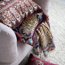 Load image into Gallery viewer, Tibetan Tigers Cotton Slub Printed Throw, soft printed throw blanket with tiger motifs draped over chair beside patterned tassel pillow, lifestyle via. 
