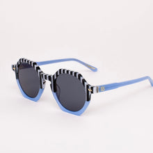 Load image into Gallery viewer, Pool Boy Blues Sunglasses, oversized hexagon sunglasses with black-and-white striped top frames and bridge, light blue lower frames and arms, dark tinted lenses with 100% UV protection against white background. 