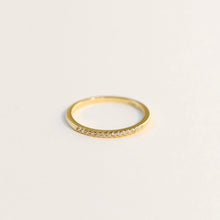 Load image into Gallery viewer, 18K gold-plated ring with white cubic zirconia stones set in a single row across a thin band.