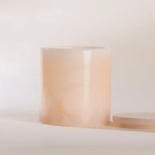 Load image into Gallery viewer, Poured NY pink onyx candle with translucent finish and matching lid, displayed on a white surface. 
