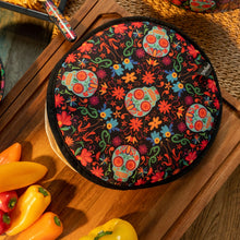 Load image into Gallery viewer, Day of the Dead Fabric Tortilla Warmer, round with aqua sugar skull and colorful floral design on black background with black trim, displayed on wooden board with peppers.