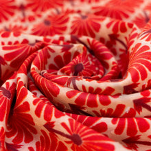 Load image into Gallery viewer, Rouge Palms Infinity Scarf, close-up of loosely gathered cream fabric with red palm-inspired patten.