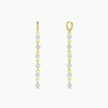 Load image into Gallery viewer, 18K gold-plated drop pearl earrings with six freshwater pearls suspended from a chain against a white background. 