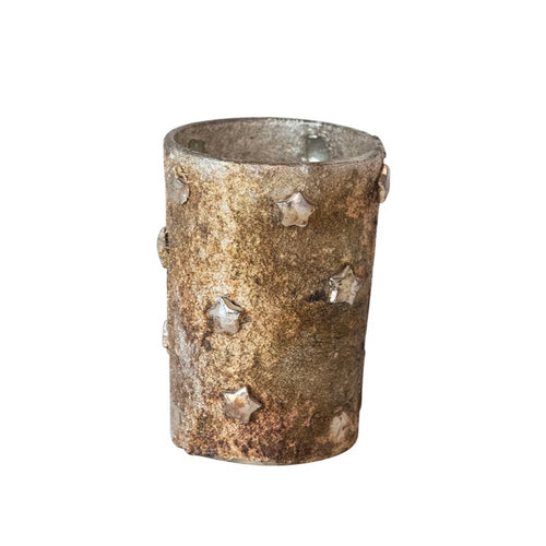 Textured plaster votive with stars on a white background. 