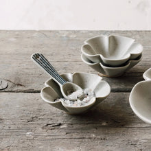 Load image into Gallery viewer, Element mini spoon, stoneware with blue stripe pattern, resting in a small dish with coarse salt, displayed on a wood surface. 