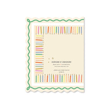 Load image into Gallery viewer, Birthday Cake and Candles Scallop Card, back of cream rectangular greeting card with scalloped edges, colorful candle border, green wavy trim, printed brand text, displayed on white background. 