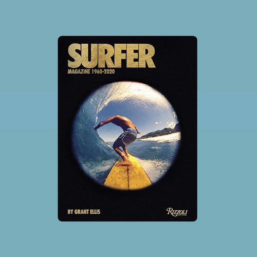 Book cover of Surfer: Magazine 1960-2020 by Grant Ellis featuring a fisheye view of a surfer riding inside a blue wave while standing on a yellow surfboard, with sunlight glinting off the water.  Book displayed against a blue background.