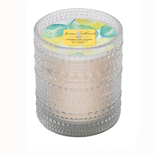 Candle in a clear bubble texture glass holder with a green and yellow label on a white background.
