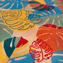 Load image into Gallery viewer, Exotic Leaves Infinity Scarf, close-up of cotton fabric with multicolor abstract tropical leaf pattern in coral, red, light blue, green and mustard tones. 