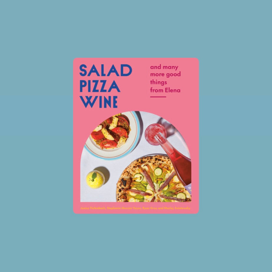 Book cover of Salad Pizza Wine featuring a bright pink background with a table setting that includes a salad bowl, a pizza topped with green vegetables, a glass bottle pouring red wine, and a lemon.  Book title in blue letters. Book against a light blue background.  