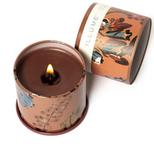 Load image into Gallery viewer, Terra Tabac Vanity Tin Candle, lit candle with brown wax in terracotta-toned floral tin with blue and brown botanical design, with lid beside candle against white background. 