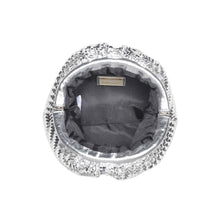 Load image into Gallery viewer, Top view of the opened silver woven vegan-leather half-moon crossbody bag showing the dark gray fabric lining and interior label, displayed against a white background. 