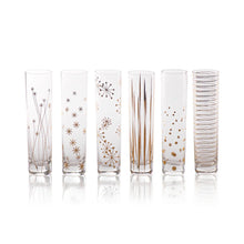 Load image into Gallery viewer, Six clear glass champagne flutes with assorted gold design decal designs on a white background.
