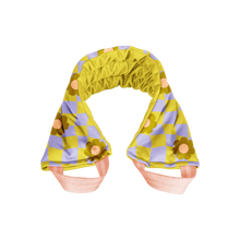 Load image into Gallery viewer, Weighted neck wrap in a yellow and lavender checkered pattern with orange flower accents and pale pink straps, displayed against a black and gray checkered background. 