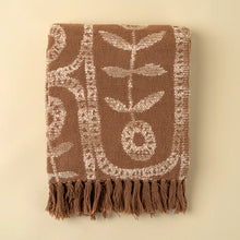 Load image into Gallery viewer, Folded brown cotton throw blanket with a white marigold floral pattern and brown fringe trim, displayed on a white background.