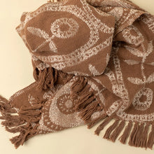 Load image into Gallery viewer, Brown cotton throw blanket with a white marigold floral pattern and brown trim, shown draped on a white background.