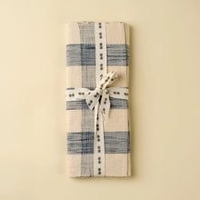 Load image into Gallery viewer, Folded blue-and-cream gingham table runner against a cream background. 