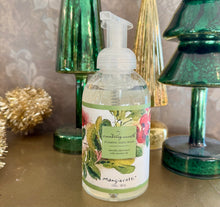 Load image into Gallery viewer, Clear pump bottle of "Cranberry Wreath" foaming hand wash by Mangiacotti with a green and red botanical illustration of cranberry sprigs on the label, displayed on a beige surface in front of green glass Christmas trees, a gold glass Christmas tree,  and a gold tinsel accent. 
